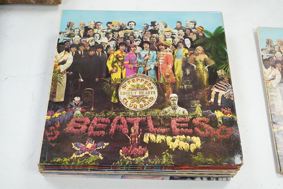 Fourteen LP record albums including eleven The Beatles and related; Sgt. Pepper’s Lonely Hearts Club Band (plus an additional three others), The Beatles at the Hollywood Bowl, Magical Mystery Tour, Revolver, etc., plus t